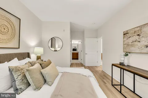 a bed room with a bed mirror and a window