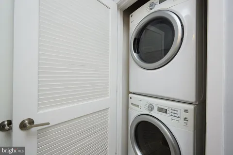 a close view of a utility room with dryer and washer