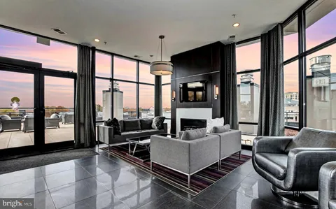 a living room with furniture tv and a large window