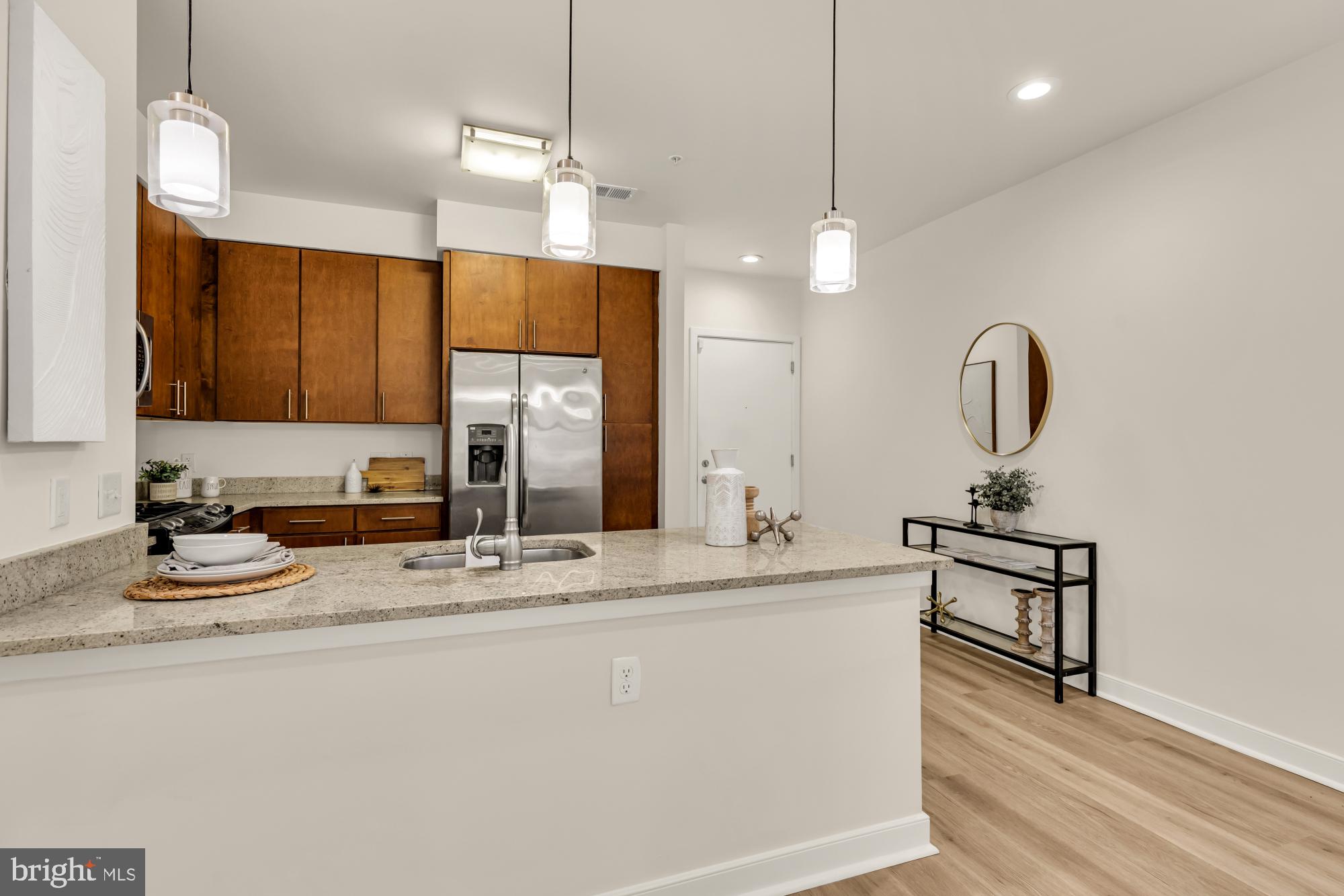 8005 13th Street, Unit 104 Silver Spring, MD 20910 - Photo 6 of 34 a kitchen with kitchen island a sink stainless steel appliances and cabinets