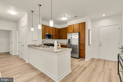 a kitchen with stainless steel appliances a refrigerator a stove a sink dishwasher and a refrigerator