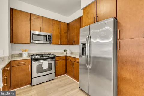 a kitchen with a refrigerator stove and microwave