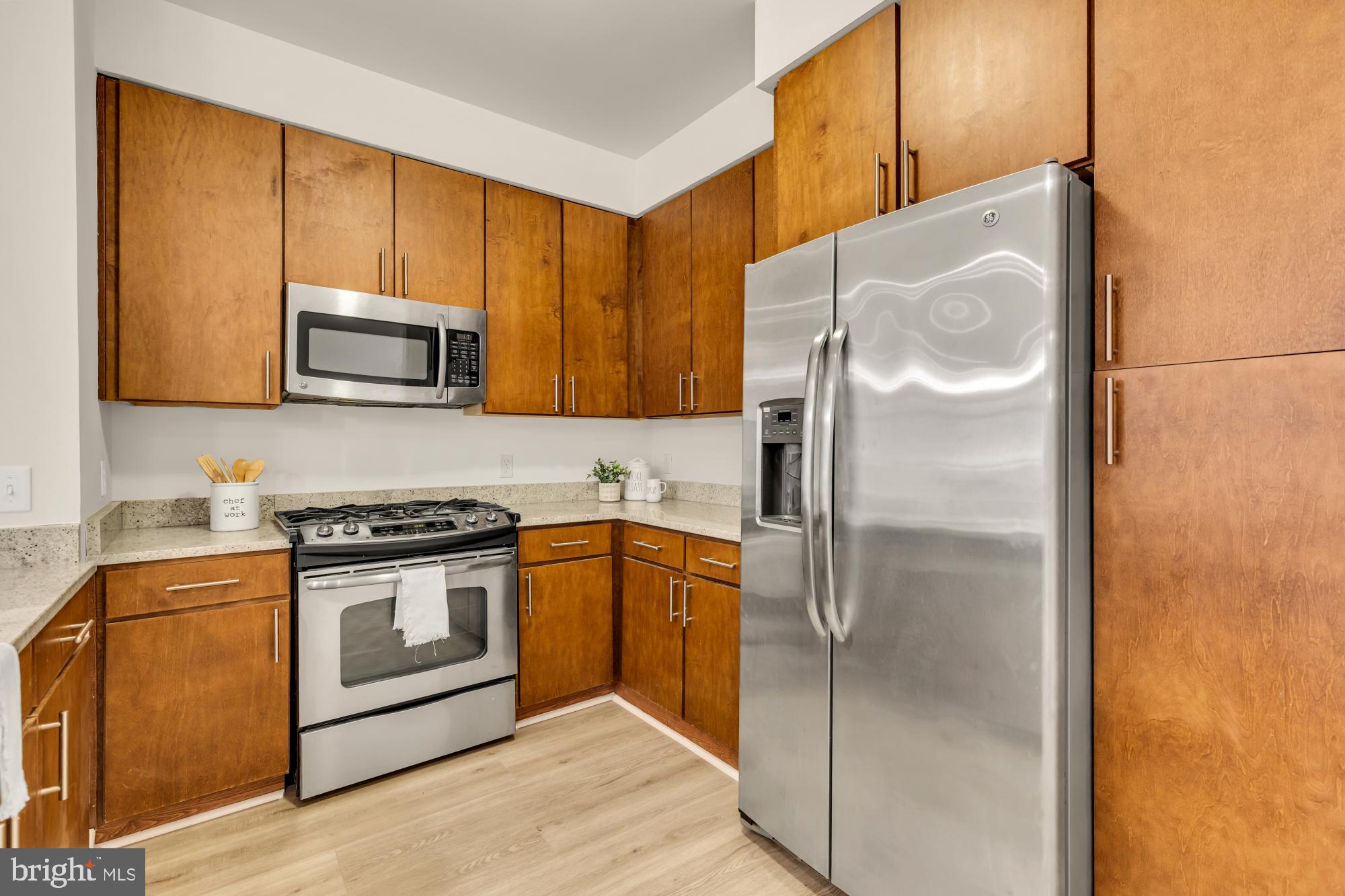 8005 13th Street, Unit 104 Silver Spring, MD 20910 - Photo 9 of 34 a kitchen with a refrigerator stove and microwave