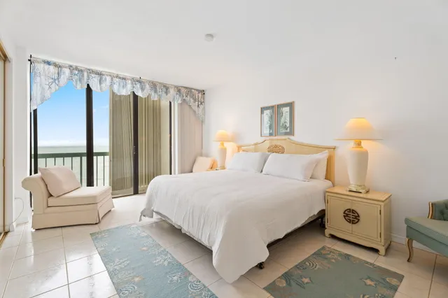 a bedroom with a bed a couch and a window