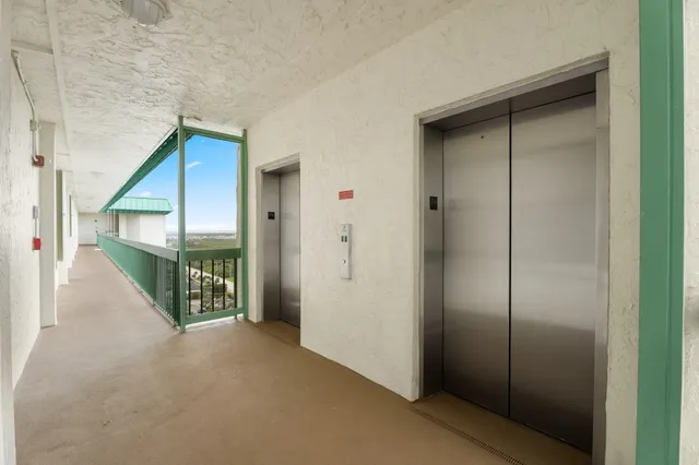 a view of a hallway with wooden shelves