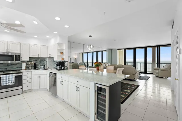 a large kitchen with kitchen island a sink stainless steel appliances and cabinets