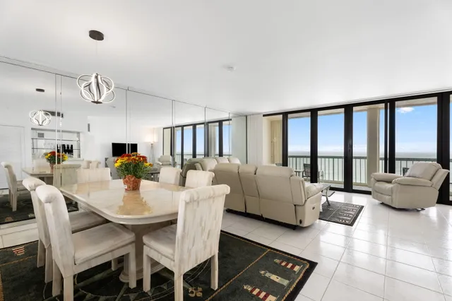 a living room with furniture and a floor to ceiling window
