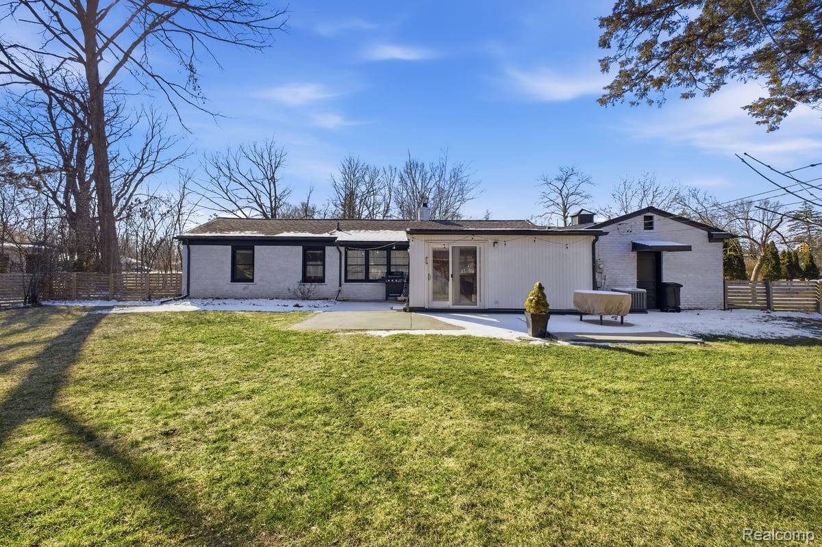 16256 West 13 Mile Road Southfield, MI 48076 - Photo 29 of 30 Rear view of house featuring a fenced backyard, a patio, and brick siding