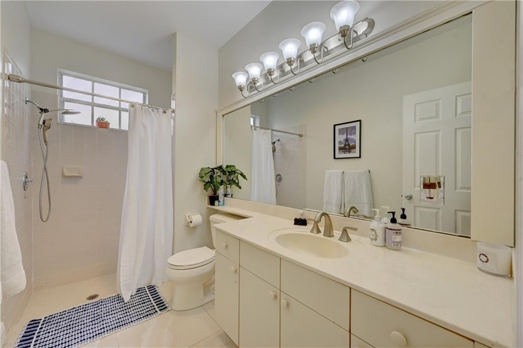8171 Hampton Wood Drive Boca Raton, FL 33433 - Photo 13 of 56 a bathroom with a sink a toilet and shower