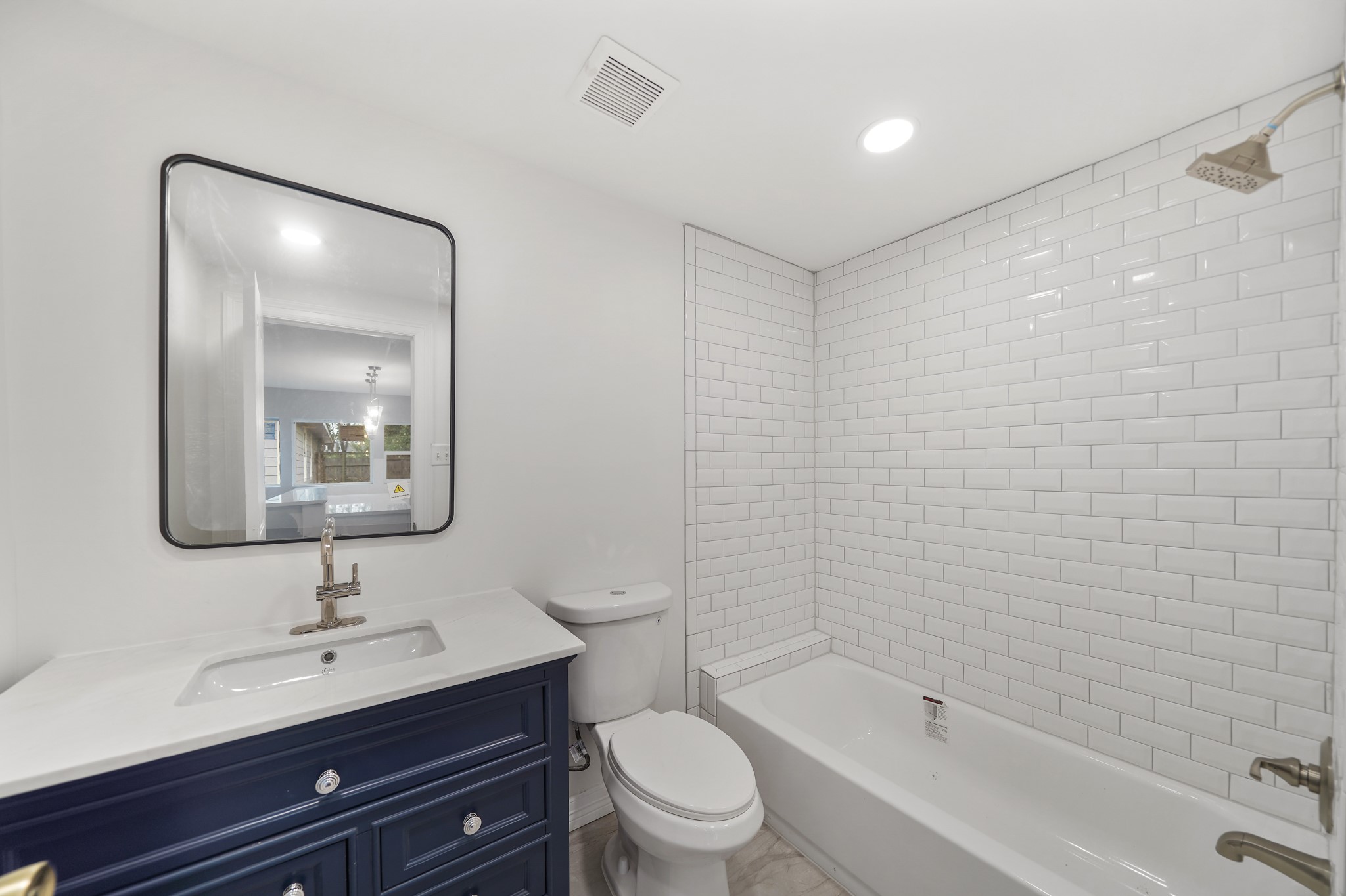 9313 Livernois Road Houston, TX 77080 - Photo 35 of 39 The bathroom in the guest house includes tile floors, recessed lighting, granite countertops, and a shower/tub combo.