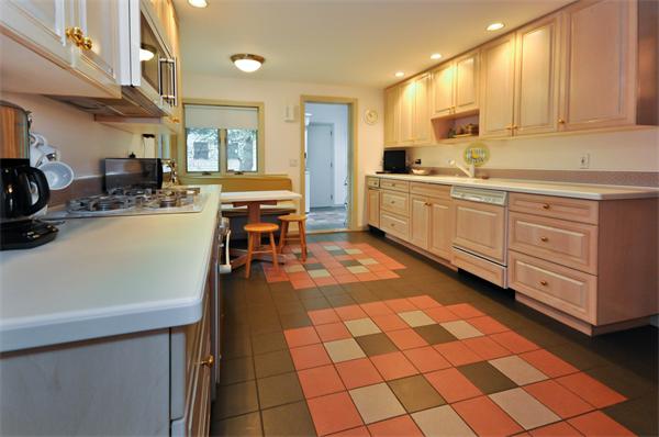 12 Ferncroft Road Newton, MA 02468 - Photo 9 of 24 a kitchen with stainless steel appliances a sink a stove top oven a counter space and cabinets