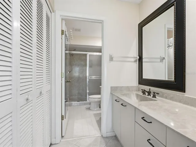 a bathroom with a granite countertop sink mirror and double