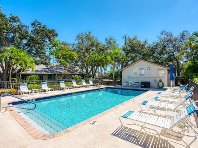 a view of a house with pool and sitting area