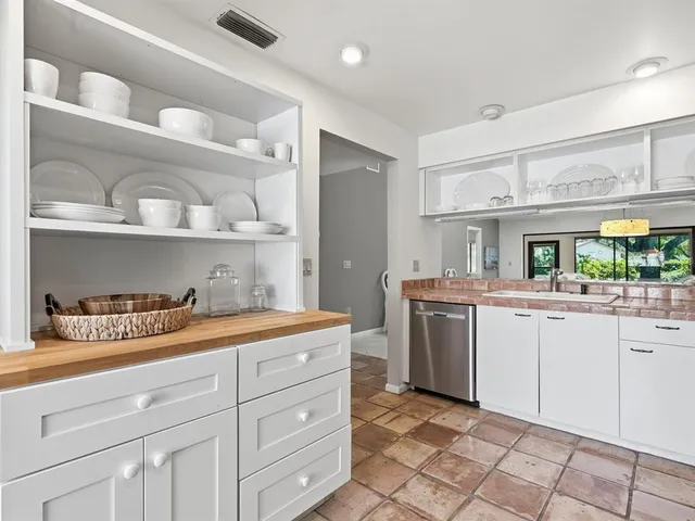 a kitchen with a sink a stove and cabinets
