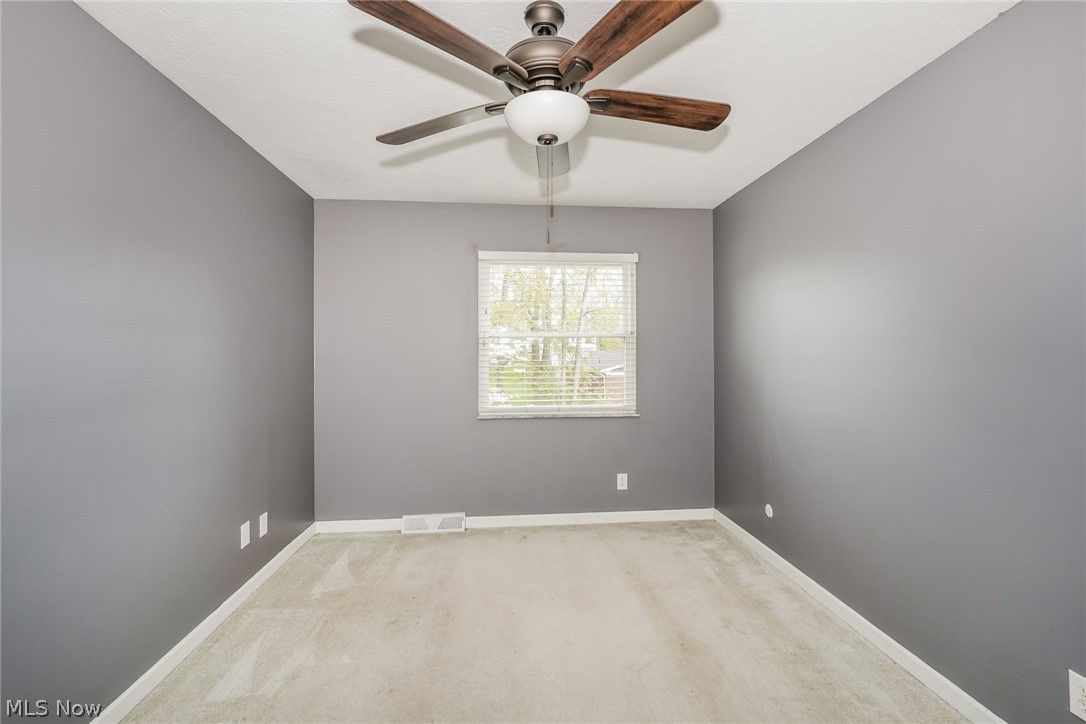 215 Randel Avenue Akron, OH 44313 - Photo 13 of 20 Unfurnished room with carpet flooring and ceiling fan