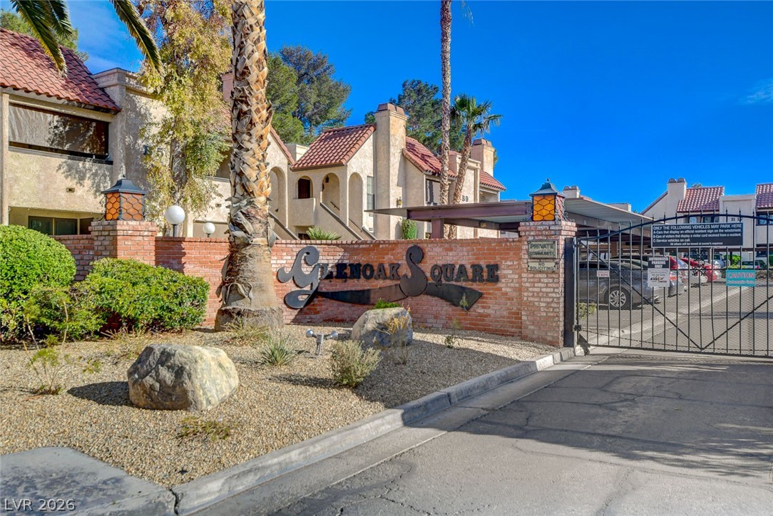 1751 East Reno Avenue, Unit 228 Las Vegas, NV 89119 - Photo 38 of 39 Secure community entrance with attractive brickwork and lush desert landscaping.