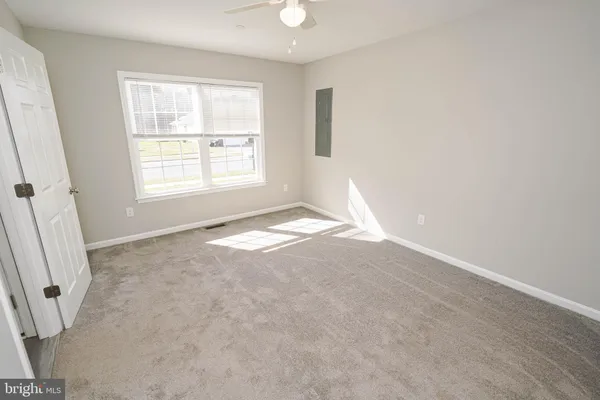 an empty room with windows and closet