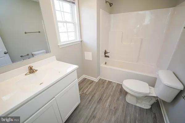 a view of a bathroom with a sink and a mirror