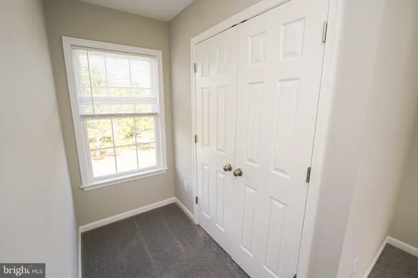 a white toilet sitting next to a bath tub
