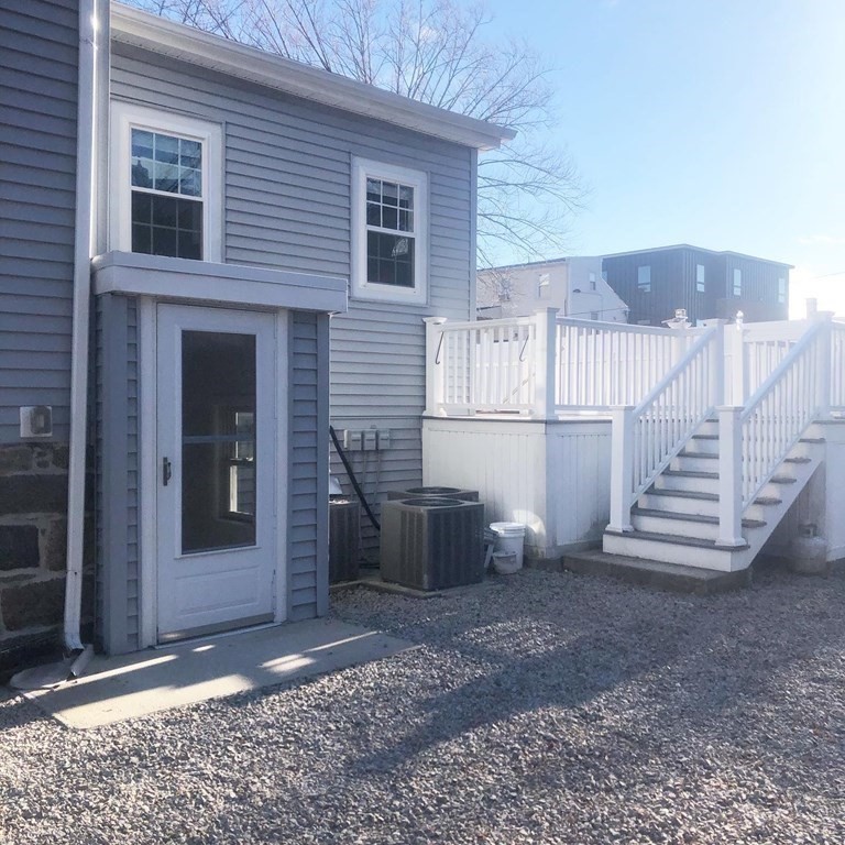 10-12 Tanglewood Road Boston, MA 02126 - Photo 3 of 17 a view of a house with stairs and wooden floor