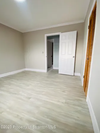 a view of an empty room with a window