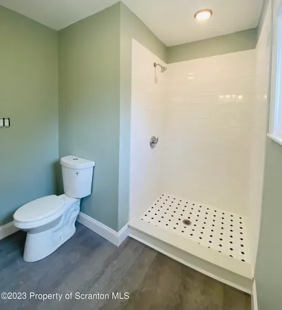 a white toilet sitting next to a bathroom sink