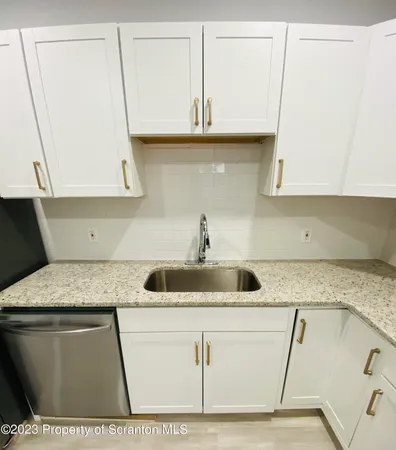 a kitchen with a sink and cabinets