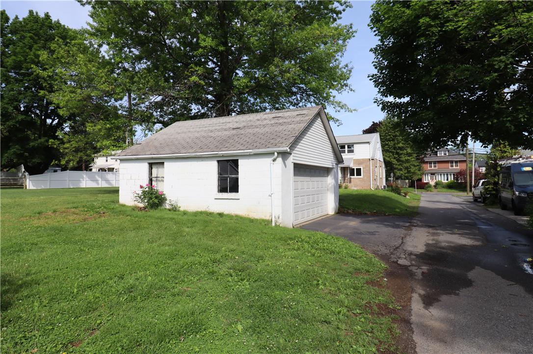 172 Harrison Street Emmaus, PA 18049 - Photo 30 of 30 A detached garage with a side-facing door sits beside a paved alleyway, offering additional utility.