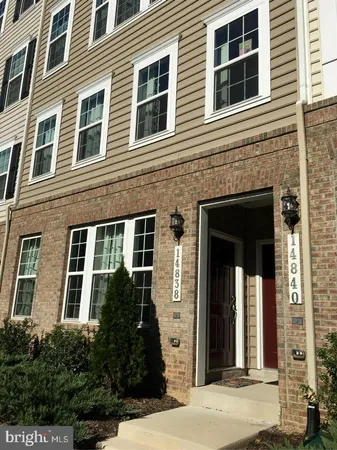 a view of a brick house with large windows