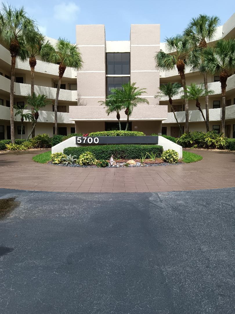 5700 Camino Del Sol, Unit 201 Boca Raton, FL 33433 - Photo 2 of 17 a view of a house with a yard and plants