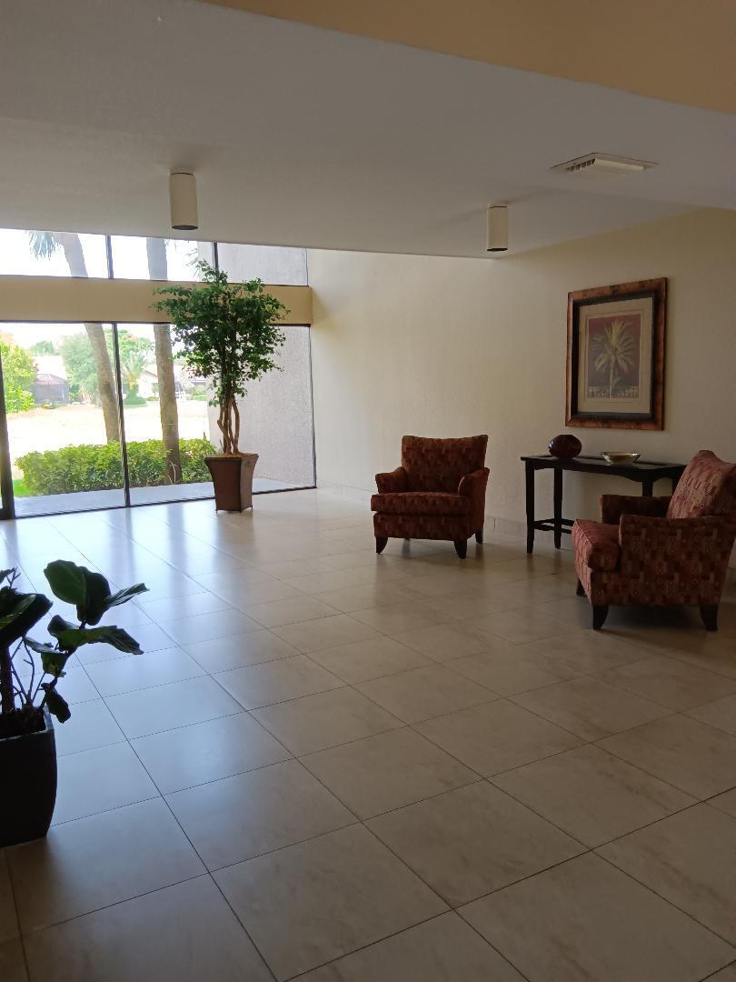 5700 Camino Del Sol, Unit 201 Boca Raton, FL 33433 - Photo 3 of 17 a living room with furniture and a potted plant
