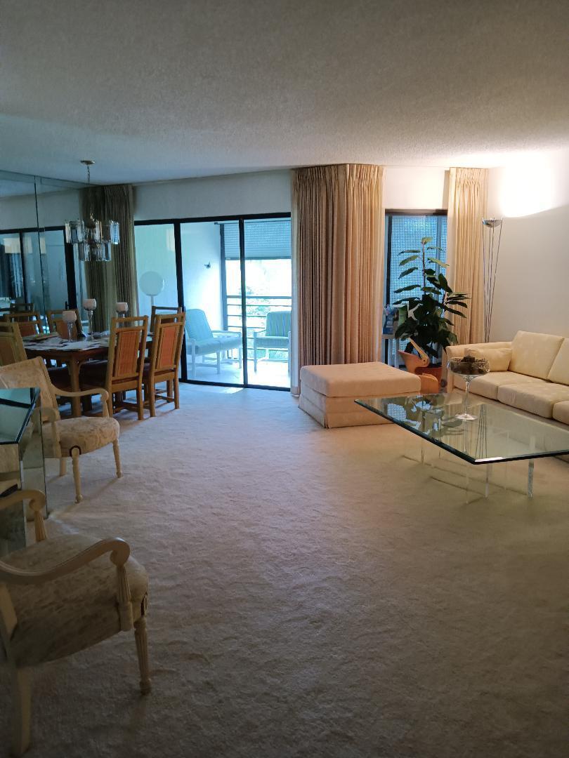 5700 Camino Del Sol, Unit 201 Boca Raton, FL 33433 - Photo 7 of 17 a living room with furniture and a large window