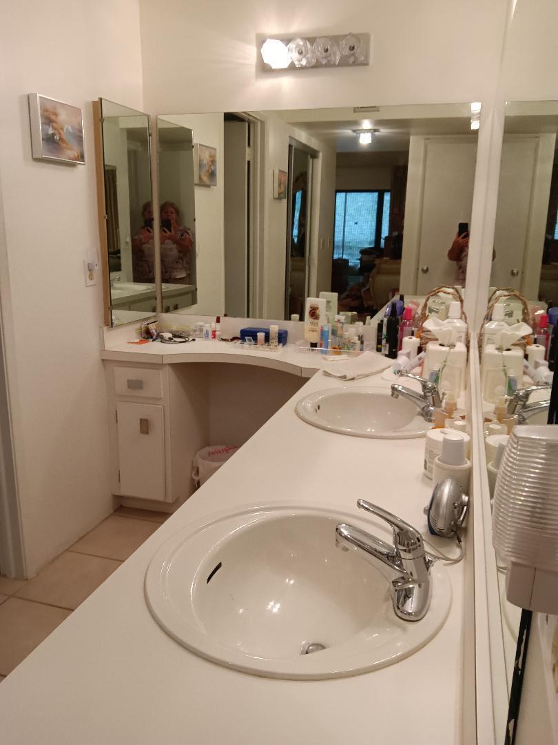 5700 Camino Del Sol, Unit 201 Boca Raton, FL 33433 - Photo 9 of 17 a bathroom with a sink and a mirror