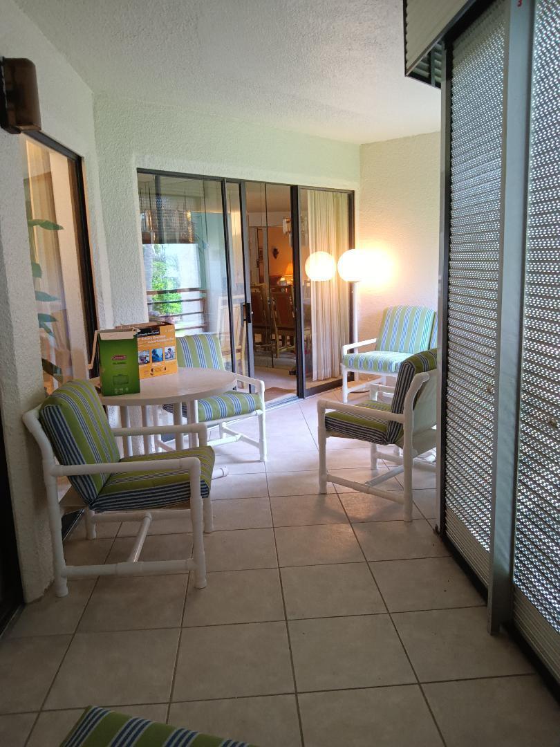 5700 Camino Del Sol, Unit 201 Boca Raton, FL 33433 - Photo 10 of 17 a living room with furniture and large windows
