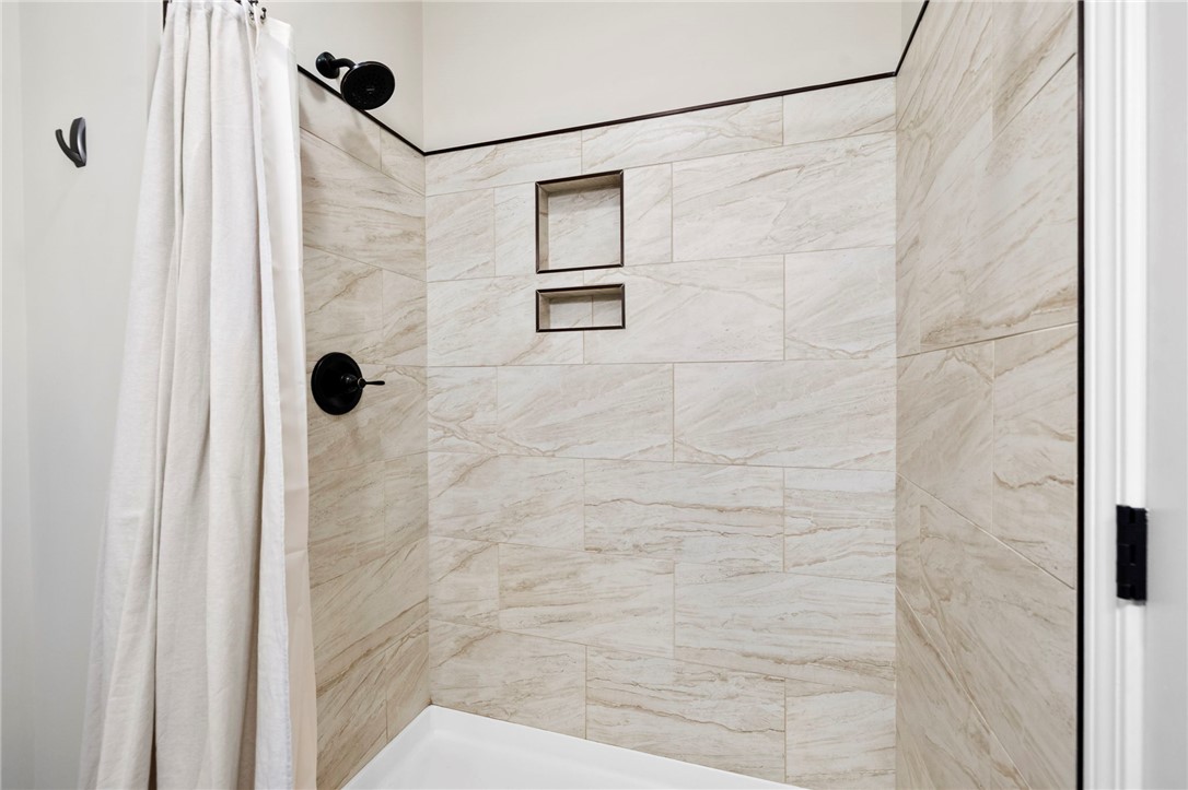 102 Colonial Court Pendleton, SC 29670 - Photo 19 of 30 This sleek shower features modern fixtures and convenient recessed shelving for a spa-like retreat.