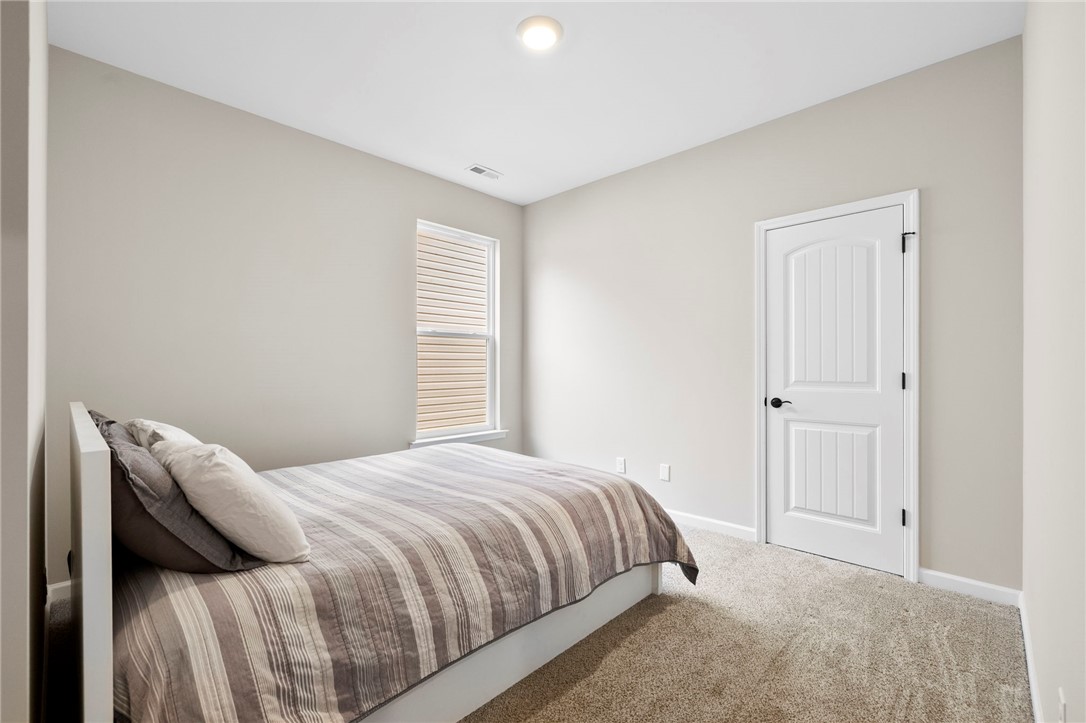102 Colonial Court Pendleton, SC 29670 - Photo 21 of 30 This cozy bedroom features plush carpeting and a bright window for abundant natural light.