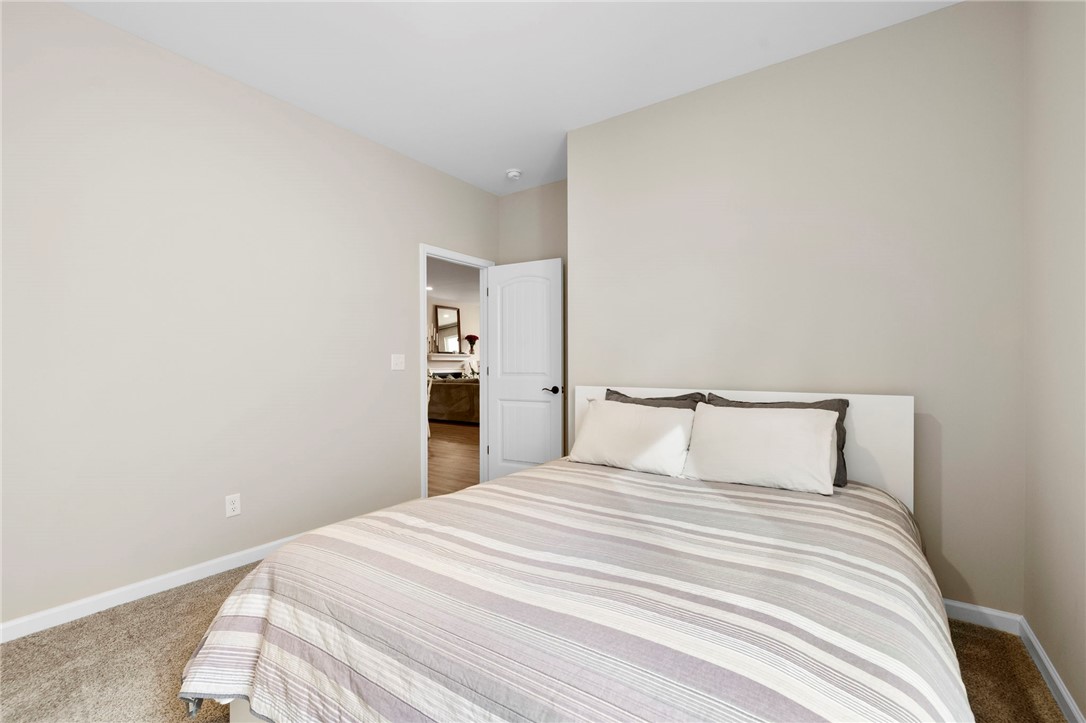 102 Colonial Court Pendleton, SC 29670 - Photo 22 of 30 This cozy bedroom features plush carpeting and an open doorway to a bright living area.