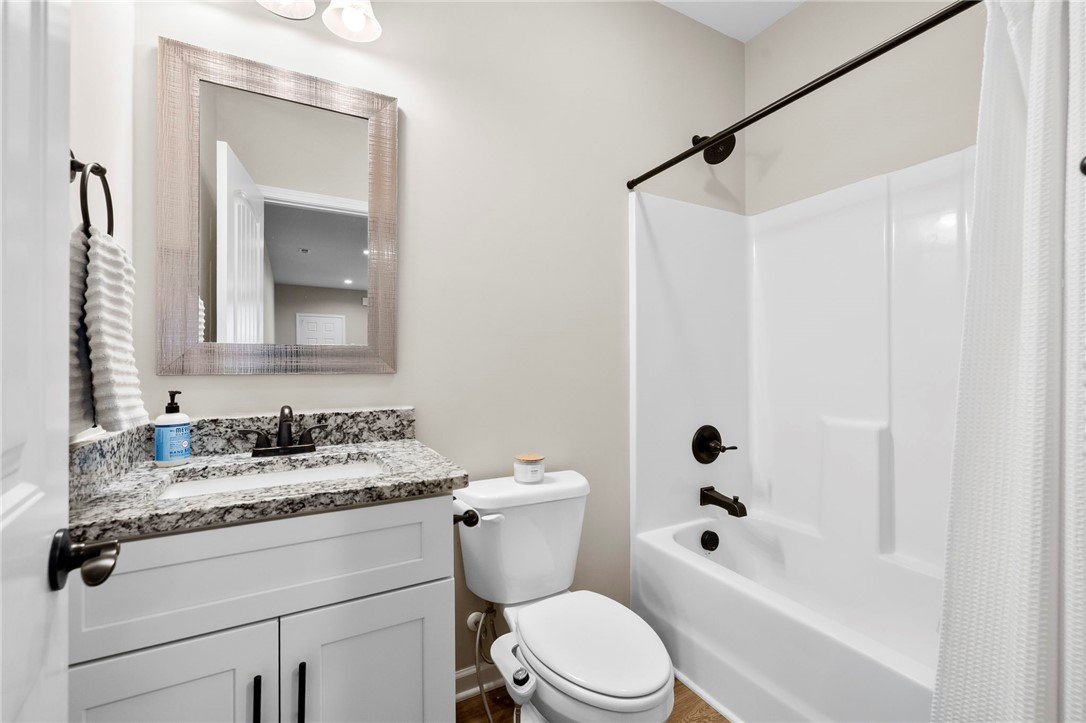102 Colonial Court Pendleton, SC 29670 - Photo 23 of 30 This bathroom features a sleek vanity and a classic tub with modern fixtures.