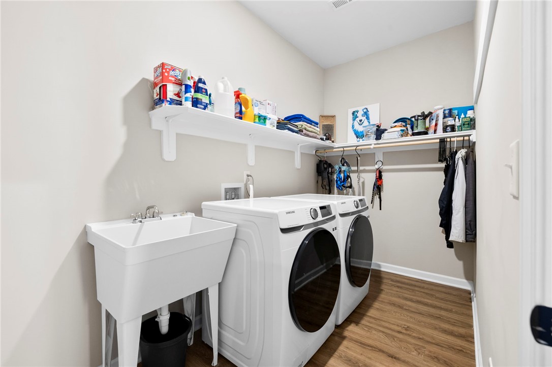 102 Colonial Court Pendleton, SC 29670 - Photo 24 of 30 This dedicated laundry area features functional appliances and convenient shelving for household essentials.