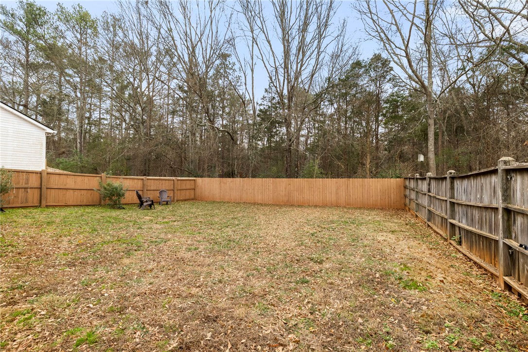 102 Colonial Court Pendleton, SC 29670 - Photo 27 of 30 This spacious yard offers ample room for outdoor activities and relaxation, with a newly installed wooden fence.
