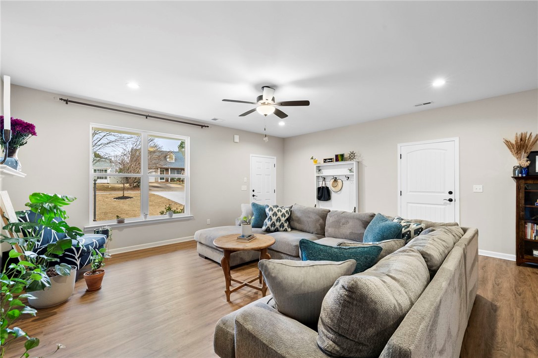 102 Colonial Court Pendleton, SC 29670 - Photo 6 of 30 Bright and airy living room with warm flooring and ample natural light.