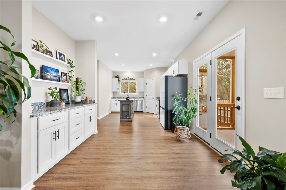 102 Colonial Court Pendleton, SC 29670 - Photo 10 of 30 This bright, open kitchen boasts beautiful wood flooring and convenient access to outdoor living.