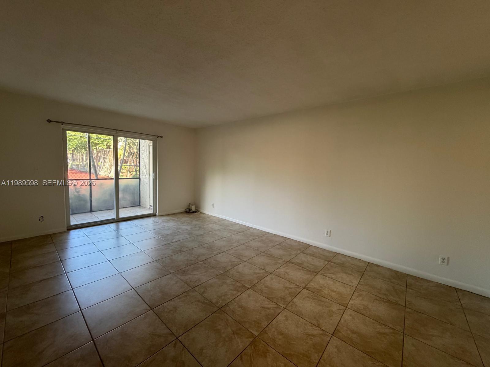 253 South Cypress Road, Unit 214 Pompano Beach, FL 33060 - Photo 5 of 25 a view of an empty room and window