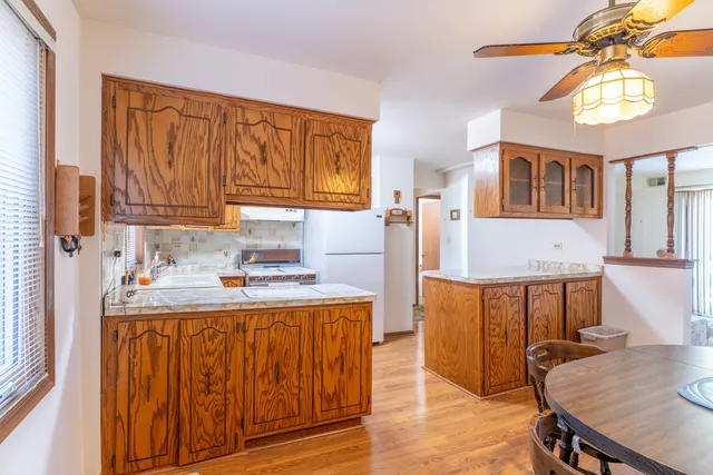 a kitchen with stainless steel appliances granite countertop a stove a sink dishwasher and cabinets with wooden floor