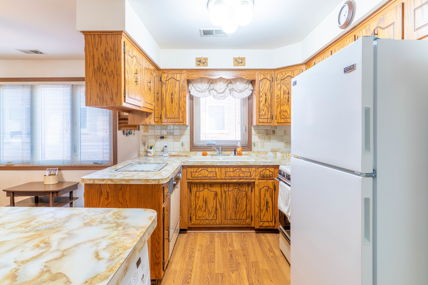6401 West 64th Place, Unit 2W Chicago, IL 60638 - Photo 12 of 41 a kitchen with stainless steel appliances granite countertop a refrigerator a sink dishwasher a stove and a dining table with wooden floor