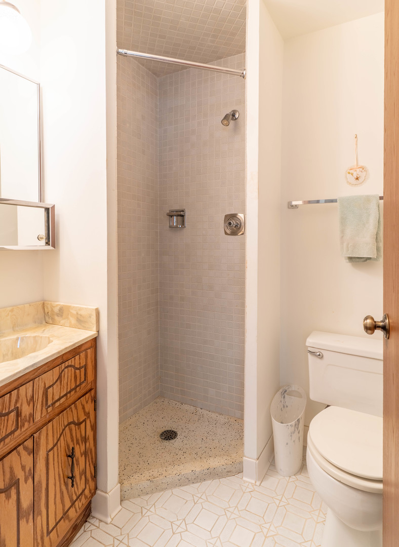 6401 West 64th Place, Unit 2W Chicago, IL 60638 - Photo 19 of 41 a bathroom with a shower a toilet and a sink