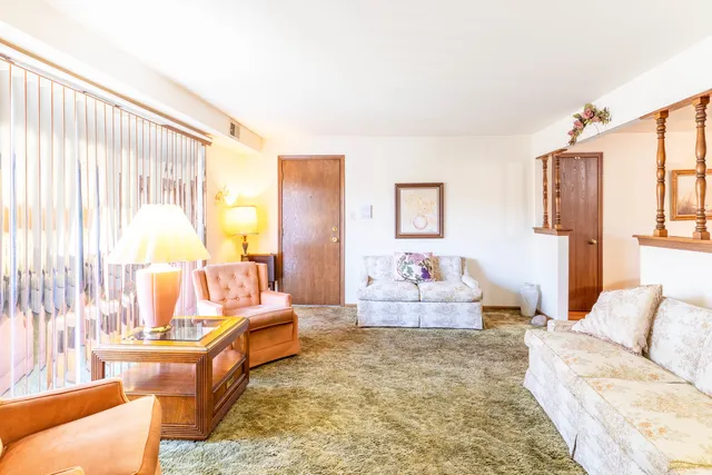 a living room with furniture and a lamp