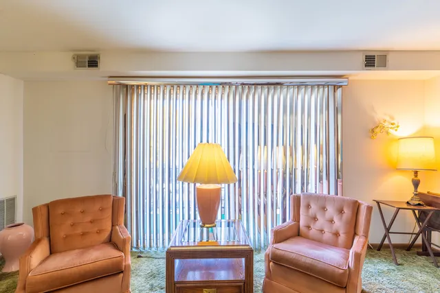 a living room with furniture and a lamp