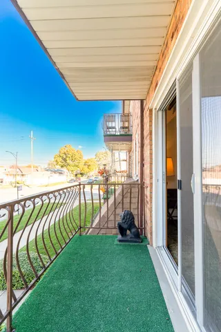 a view of a balcony with chairs and table