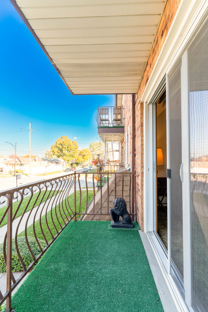 6401 West 64th Place, Unit 2W Chicago, IL 60638 - Photo 34 of 41 a view of a room with stairs and a floor to ceiling window